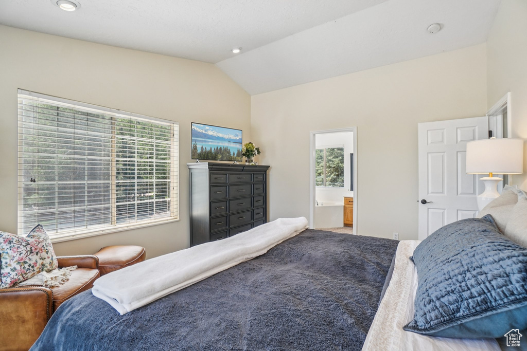 Bedroom with vaulted ceiling, ensuite bathroom, and recessed lighting