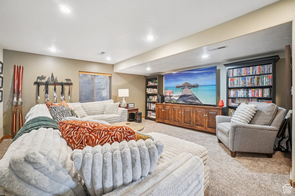 Living area with carpet floors and recessed lighting