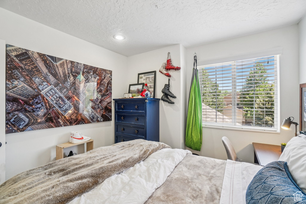 Bedroom featuring a textured ceiling and recessed lighting