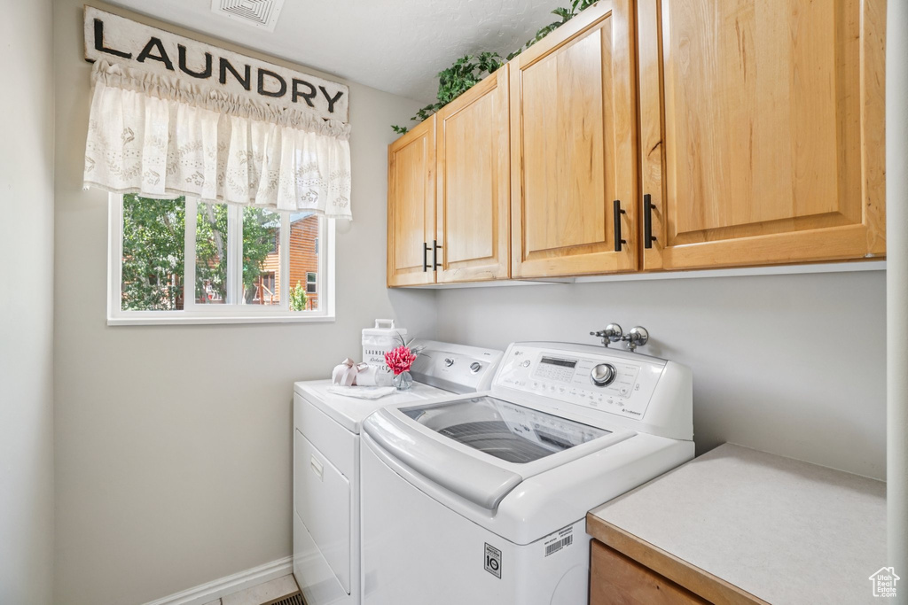 Laundry room with cabinet space and washer and dryer