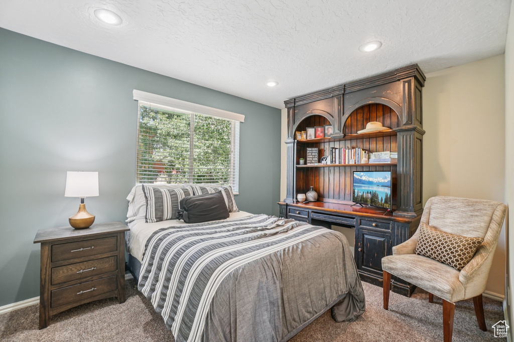 Bedroom with carpet, recessed lighting, and a textured ceiling