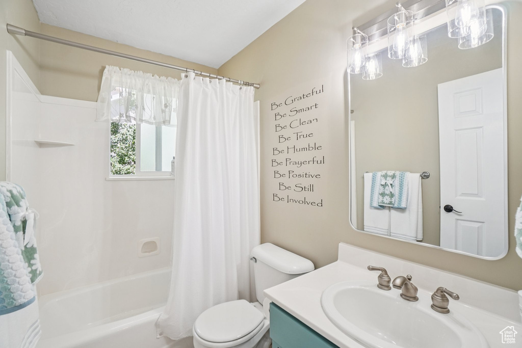 Bathroom with vanity and shower / bath combination with curtain