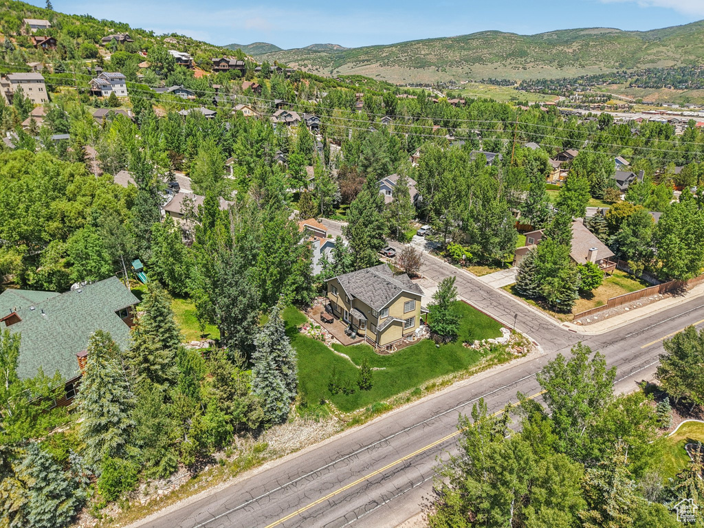 Aerial view of property and surrounding area featuring nearby suburban area