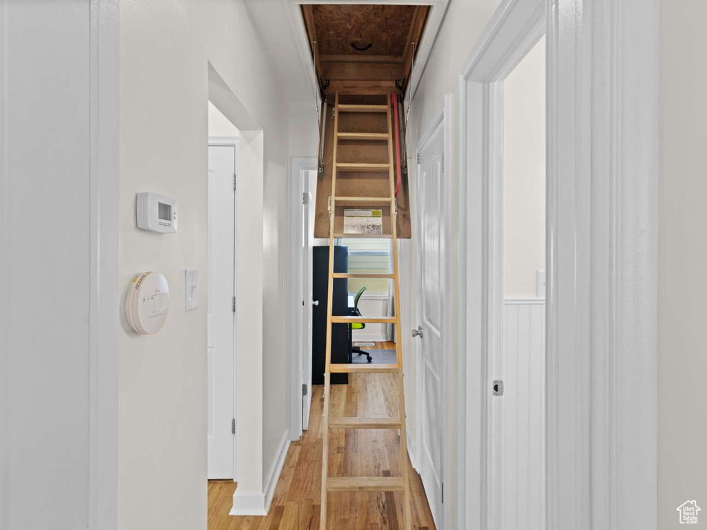 Hallway with light wood-style floors