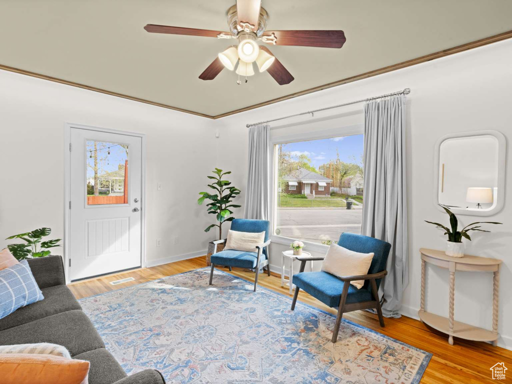 Sitting room featuring baseboards, ceiling fan, wood finished floors, and visible vents