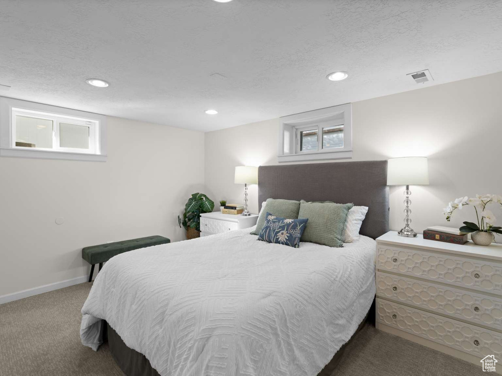 Carpeted bedroom with recessed lighting, a textured ceiling, visible vents, and baseboards