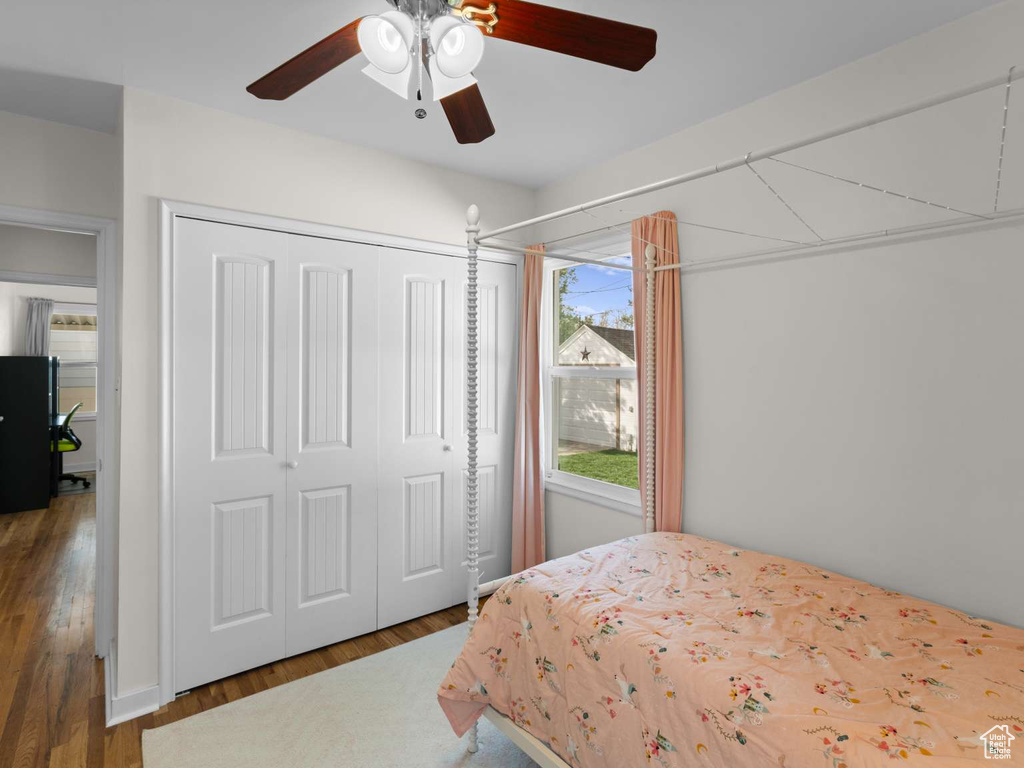 Bedroom featuring a closet, ceiling fan, and wood finished floors