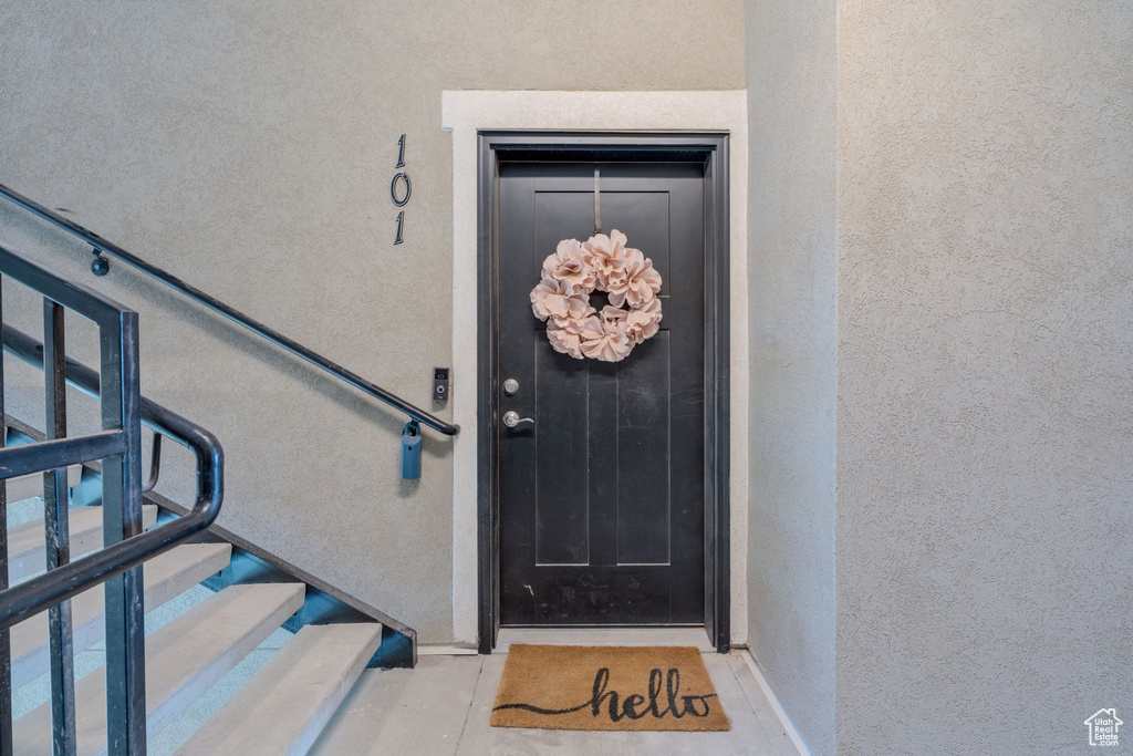 Doorway to property with stucco siding