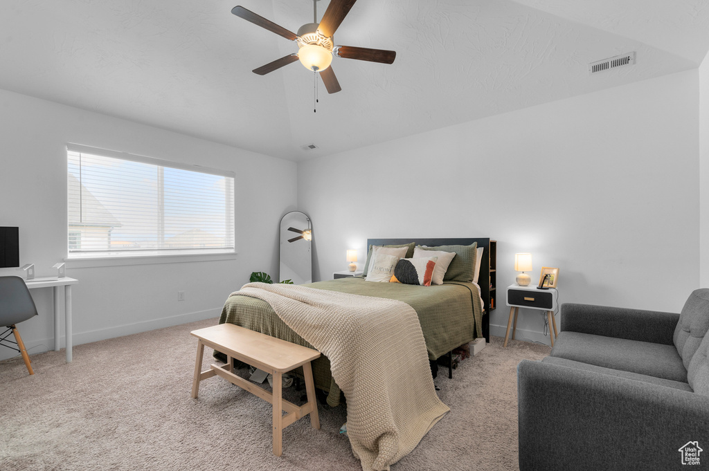 Bedroom featuring ceiling fan, carpet, vaulted ceiling, and visible vents