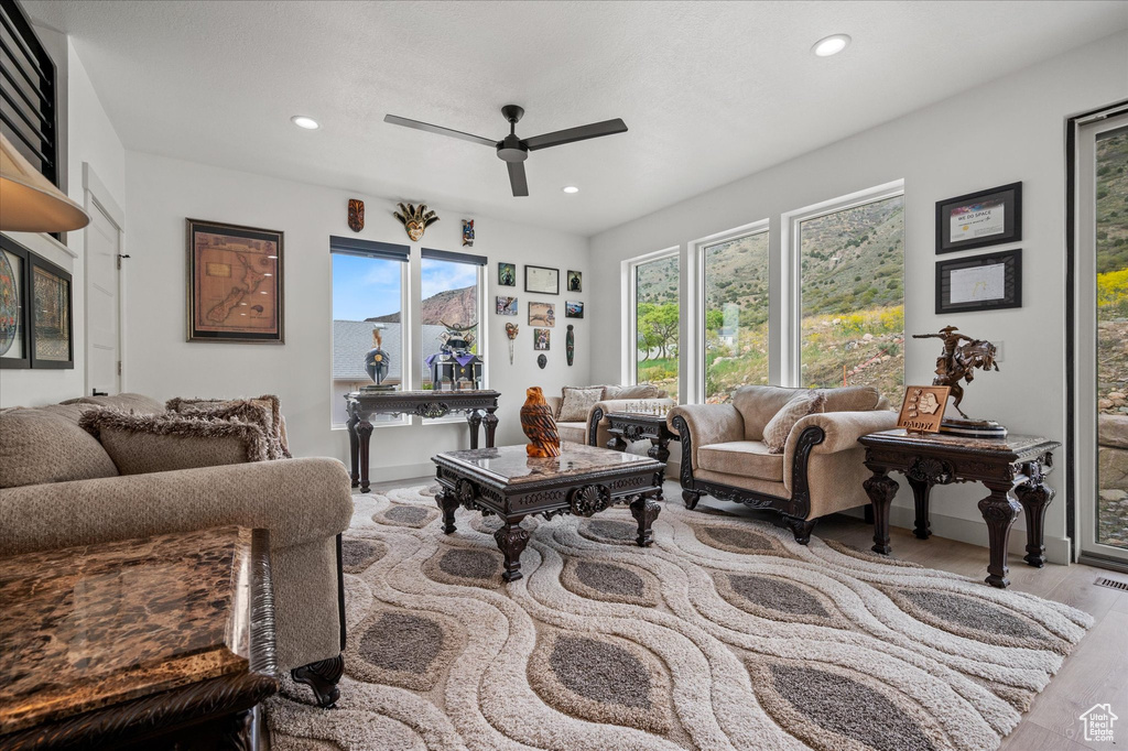 Living area with recessed lighting, ceiling fan, visible vents, and wood finished floors