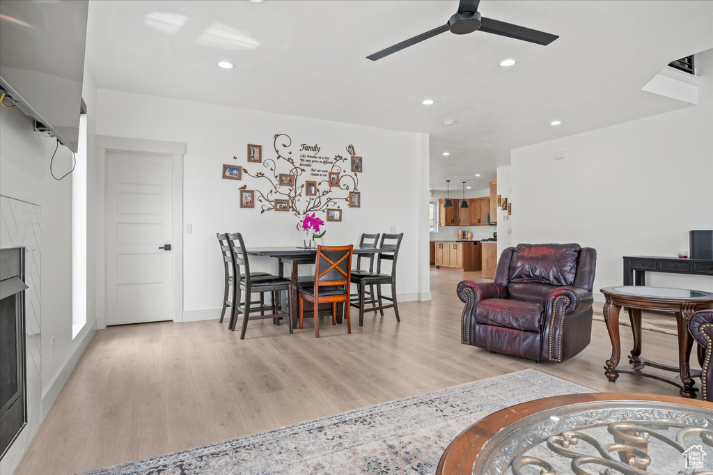 Living room with recessed lighting, ceiling fan, and light wood finished floors