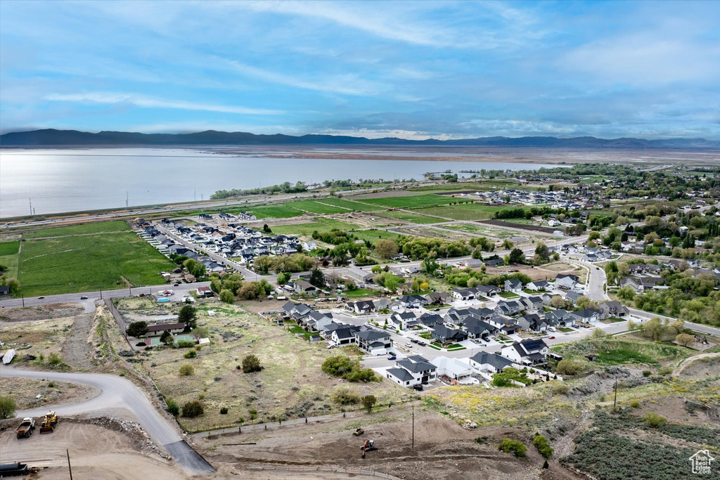 Birds eye view of property featuring a water and mountain view