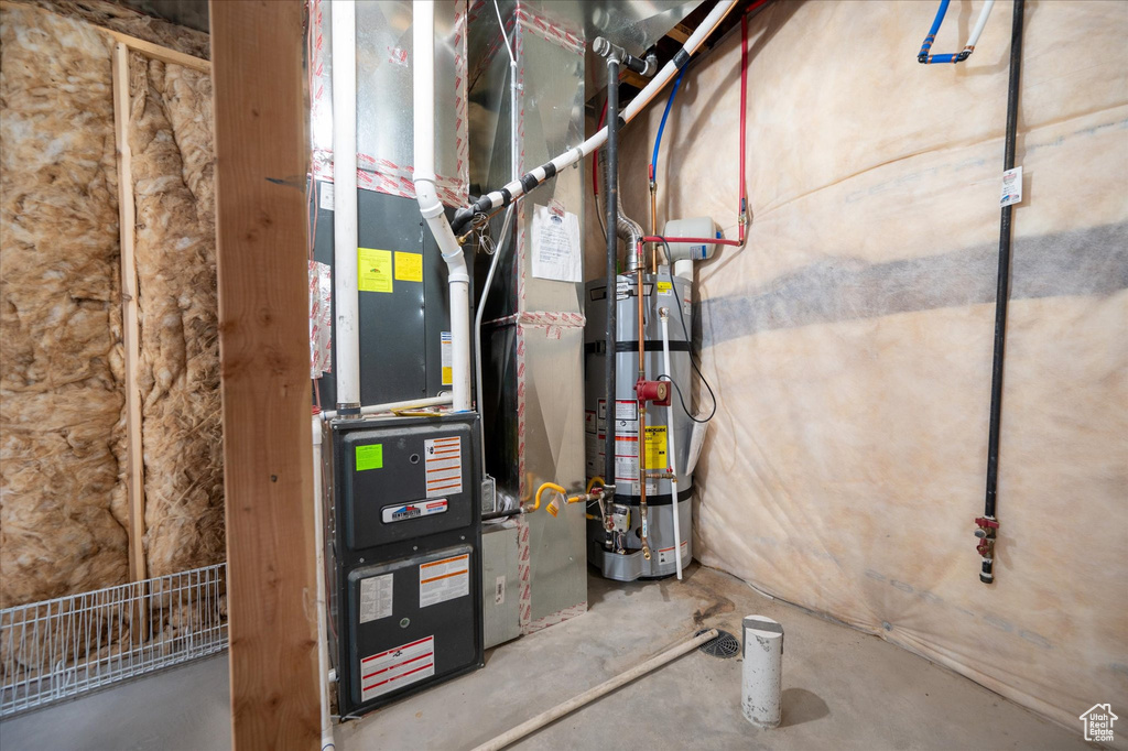 Utility room featuring secured water heater