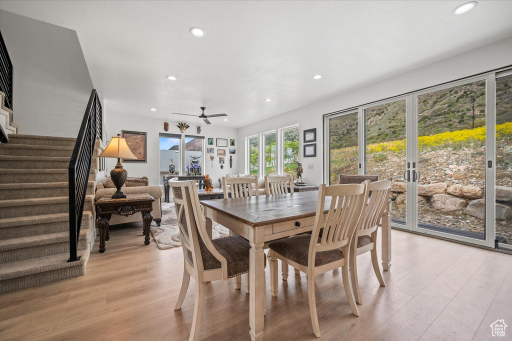Dining room with stairs, recessed lighting, a ceiling fan, and light wood-type flooring