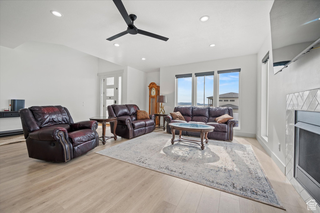 Living room with recessed lighting, ceiling fan, and light wood-type flooring