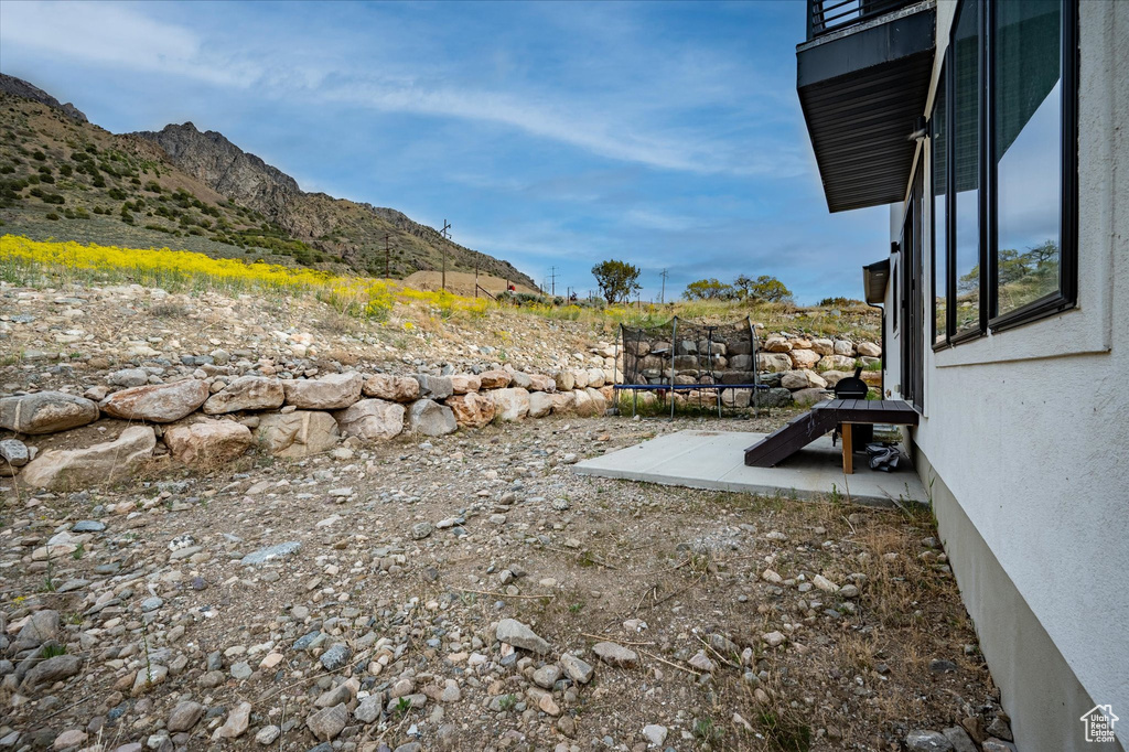View of yard with a mountain view and a trampoline