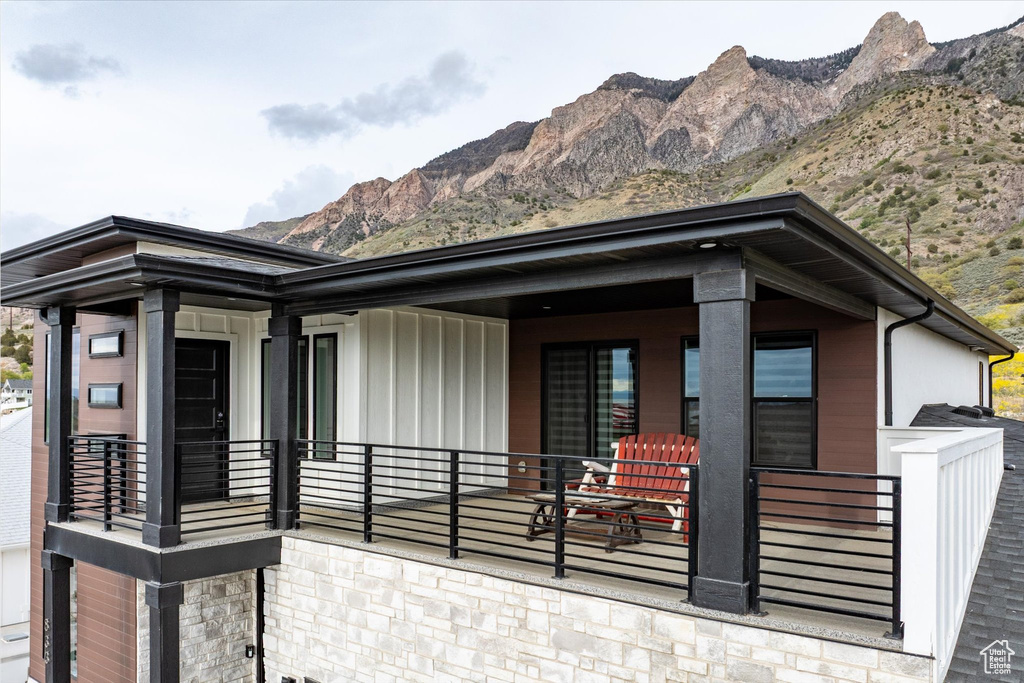 View of front of property featuring board and batten siding, a mountain view, and stone siding