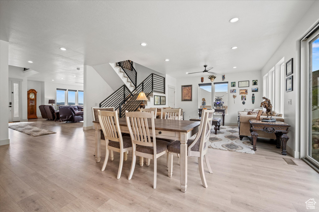 Dining room featuring stairs, baseboards, ceiling fan, recessed lighting, and light wood finished floors