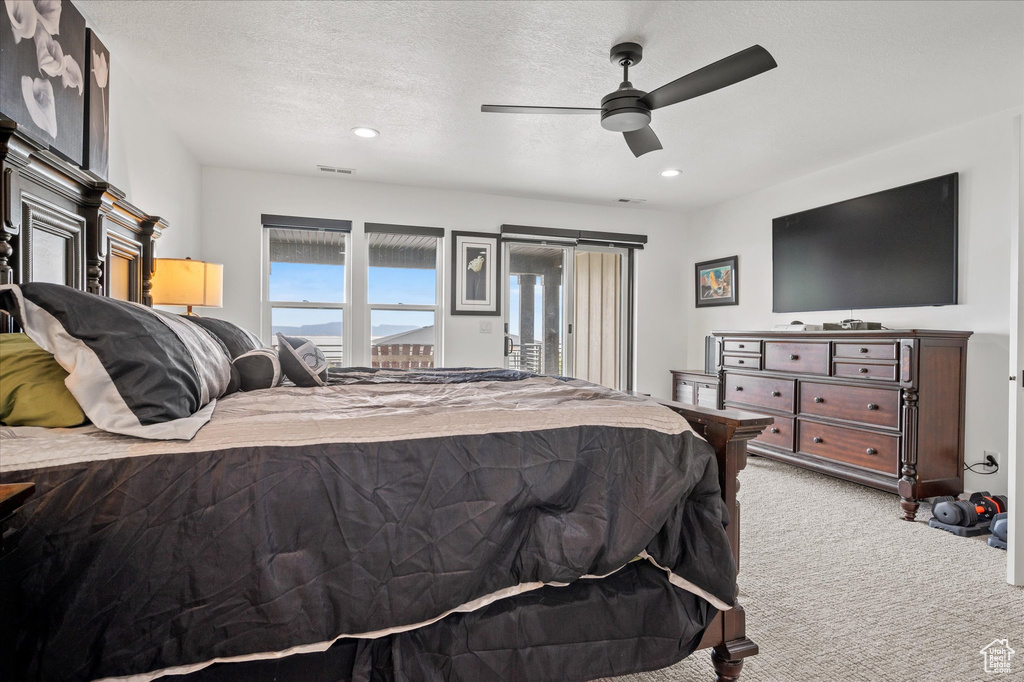 Carpeted bedroom featuring recessed lighting, a ceiling fan, visible vents, and access to exterior