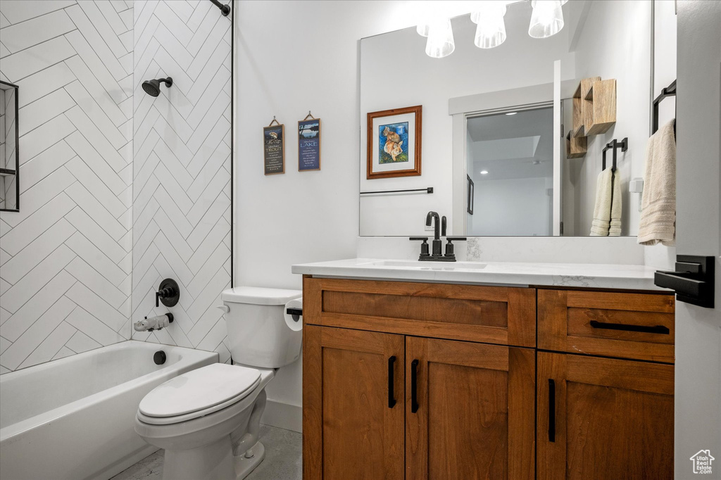 Full bathroom with toilet, bathing tub / shower combination, and vanity