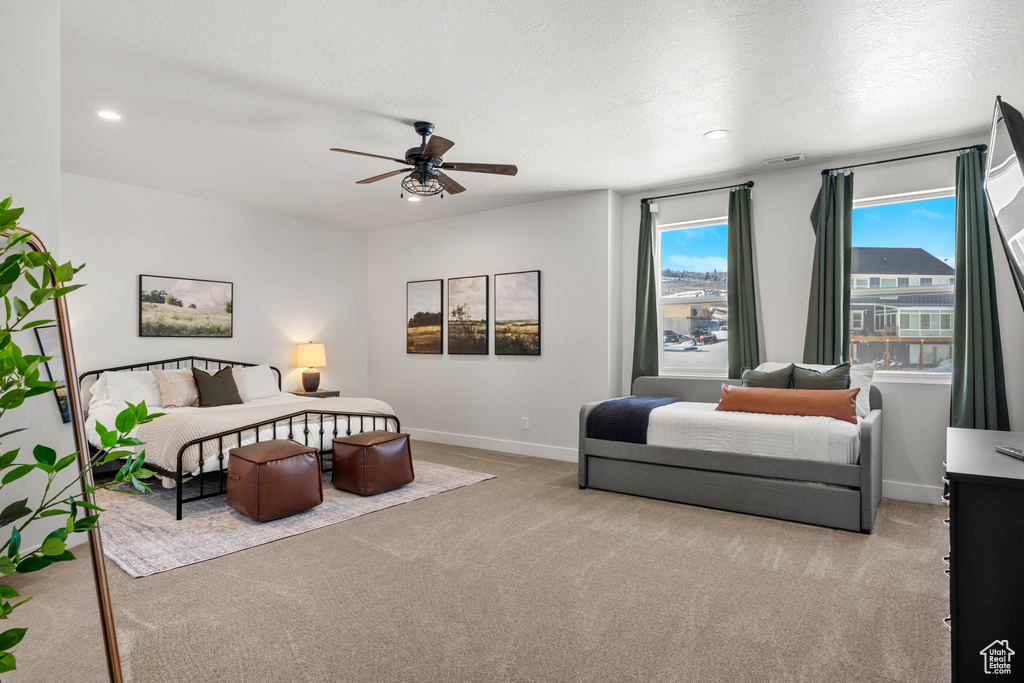 Carpeted bedroom featuring baseboards, a ceiling fan, a textured ceiling, and recessed lighting