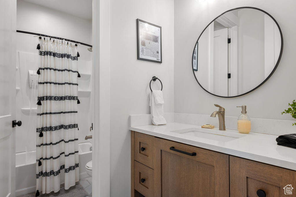 Full bathroom featuring vanity, tile patterned floors, toilet, and shower / bath combination with curtain
