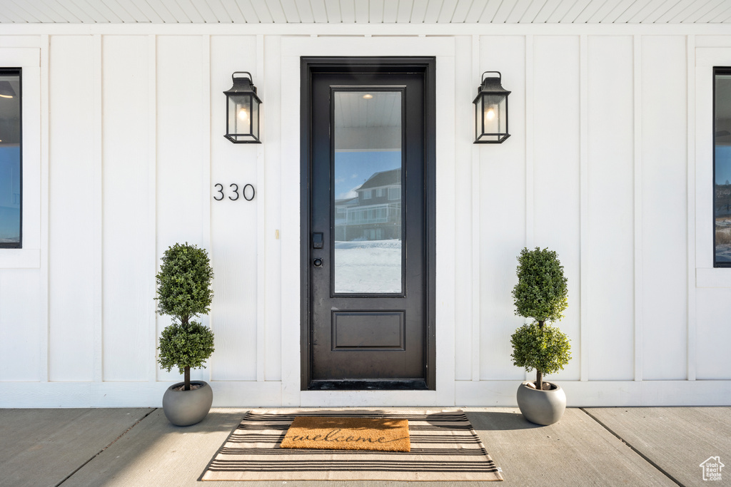 Property entrance featuring board and batten siding