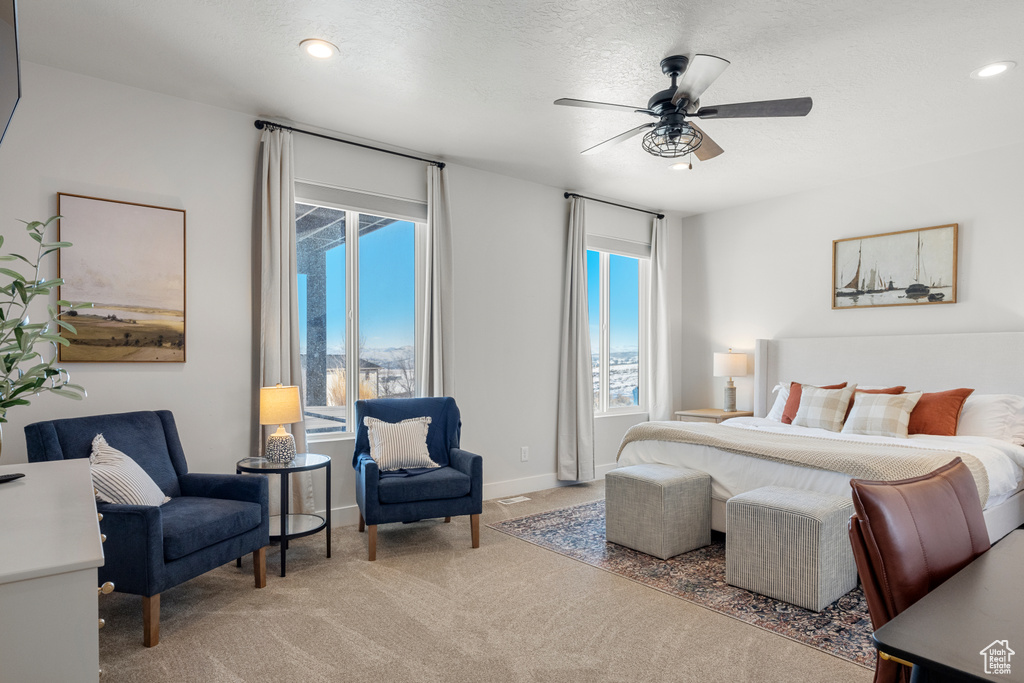 Bedroom featuring ceiling fan, a textured ceiling, light colored carpet, baseboards, and recessed lighting