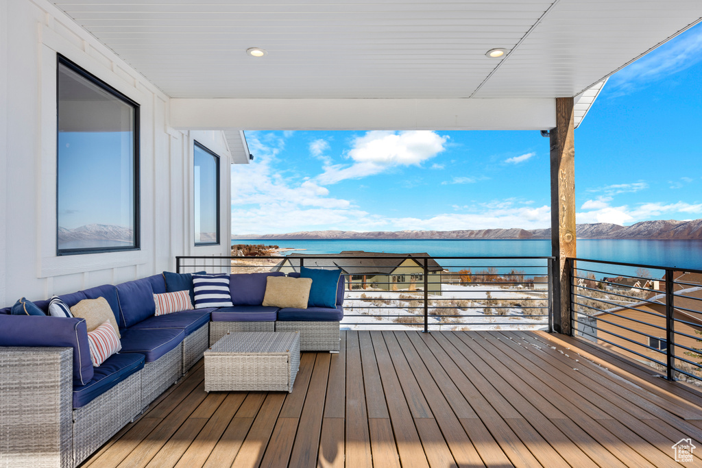Wooden deck with a water view and an outdoor hangout area