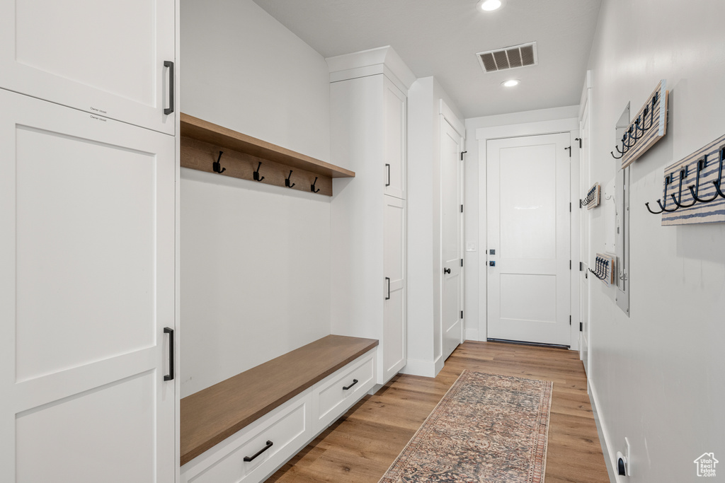 Mudroom with recessed lighting, baseboards, visible vents, and light wood-type flooring