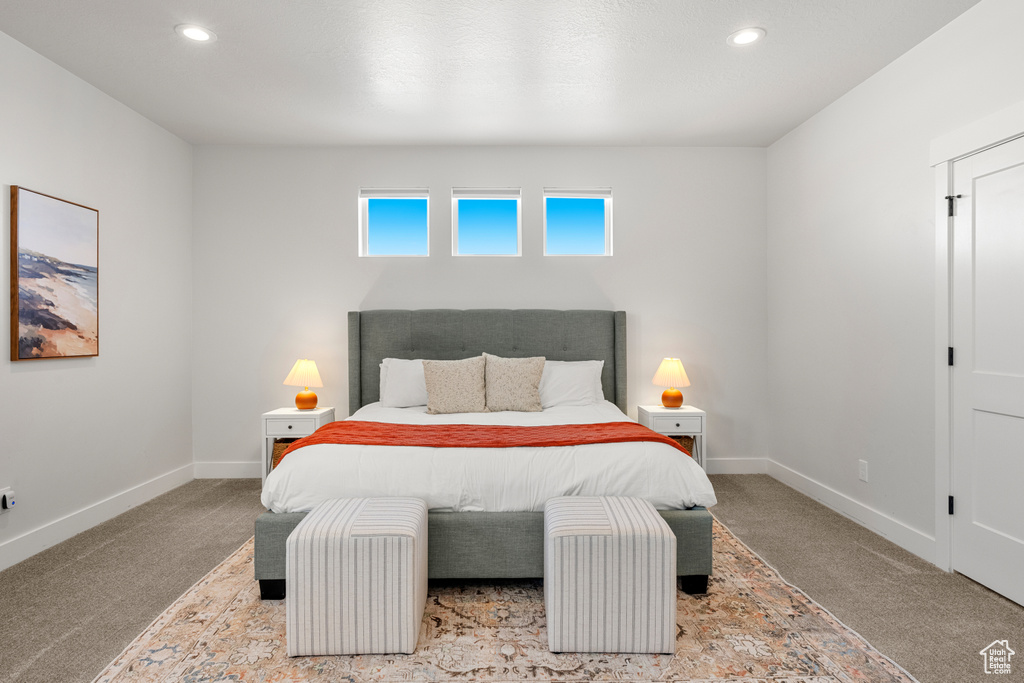 Carpeted bedroom with baseboards and recessed lighting