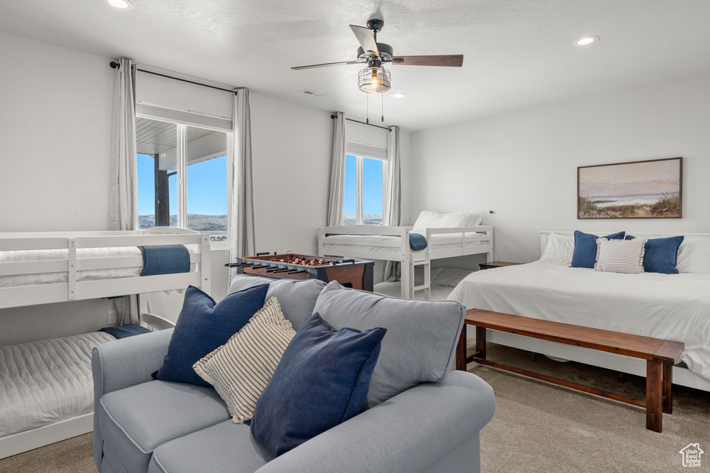 Carpeted bedroom with ceiling fan, recessed lighting, and visible vents