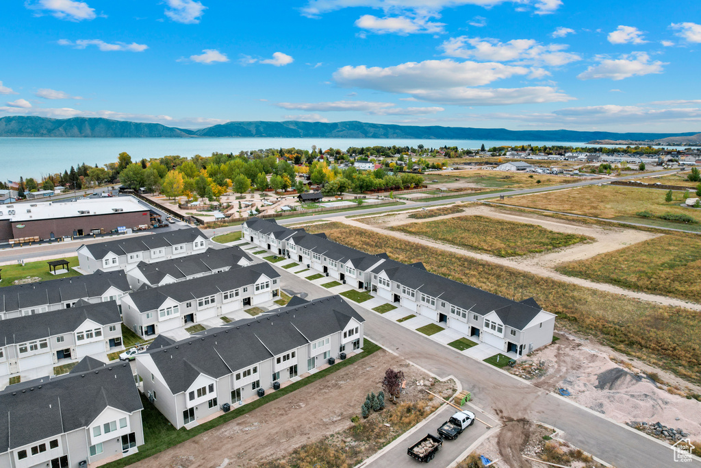 Birds eye view of property featuring a water and mountain view