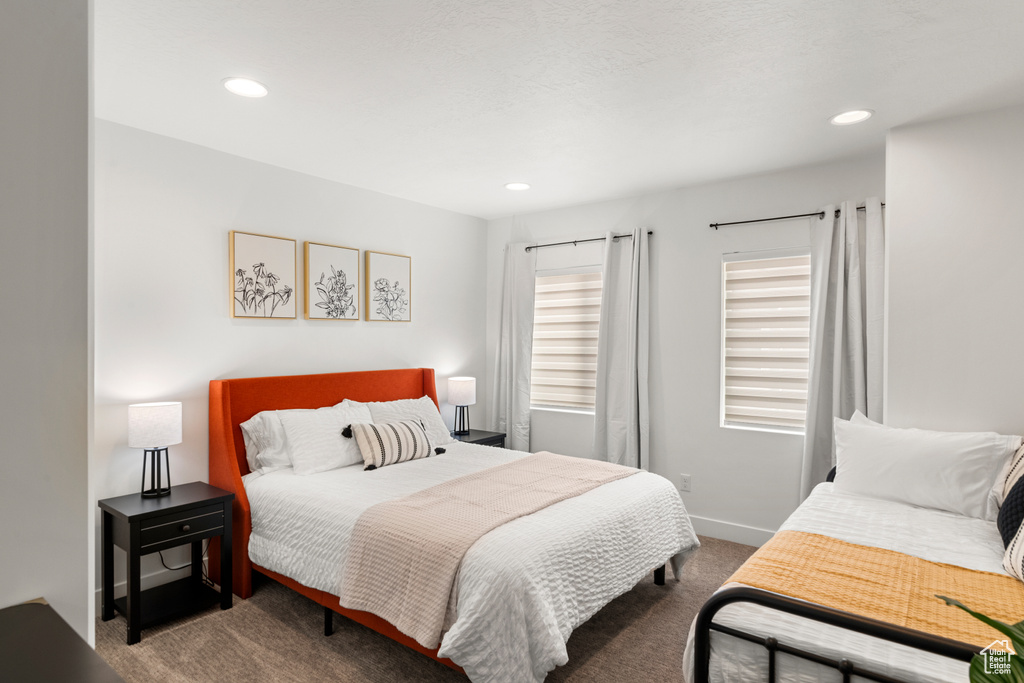 Carpeted bedroom with baseboards and recessed lighting