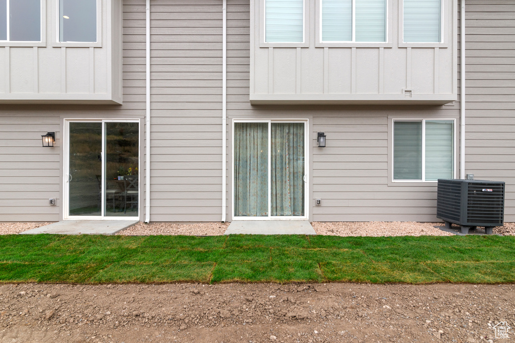 Back of property with board and batten siding and central air condition unit
