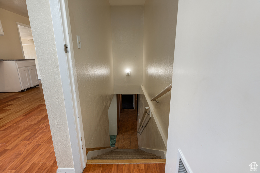 Stairs with visible vents and wood finished floors