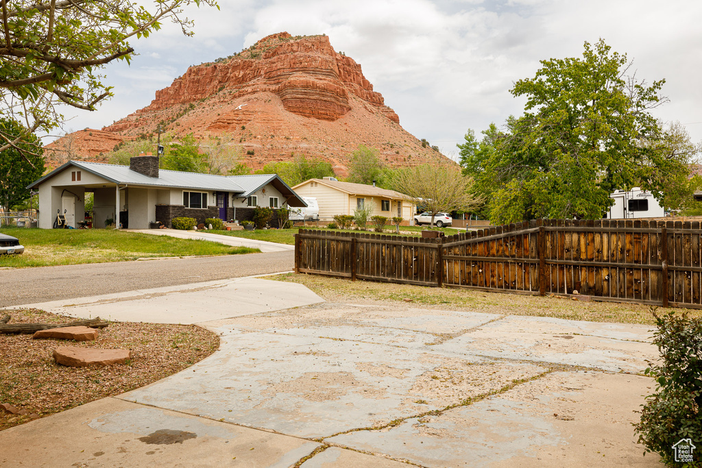 Exterior space featuring a yard, fence, and a mountain view