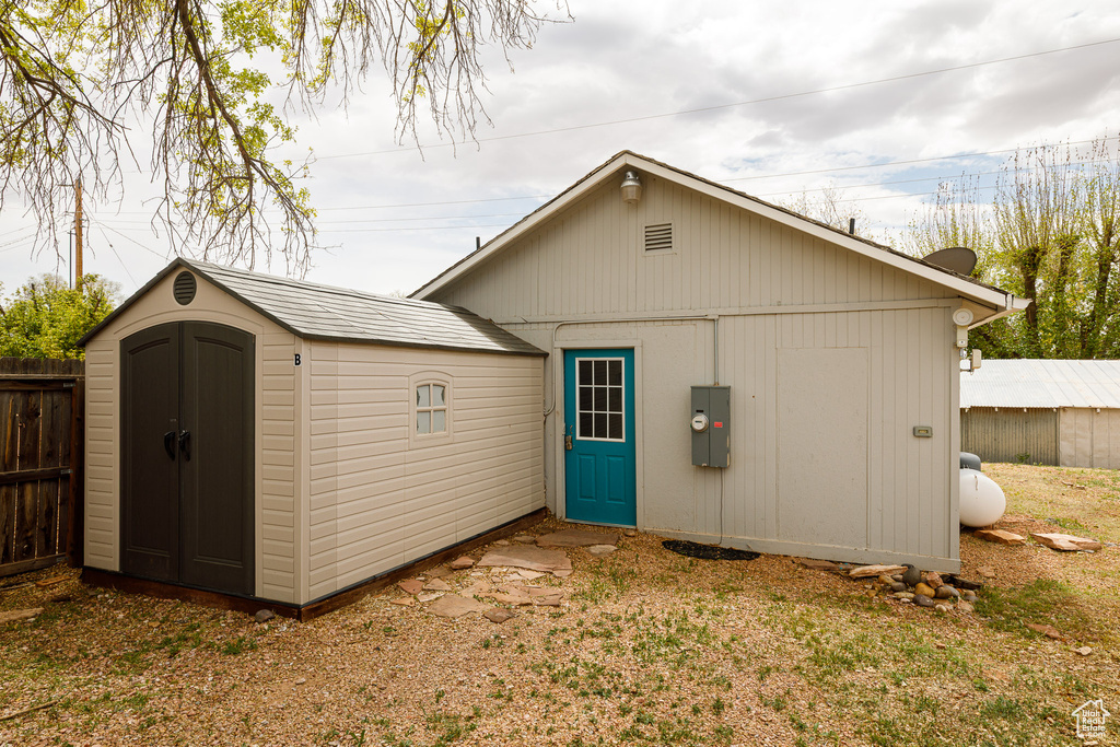 View of shed featuring fence