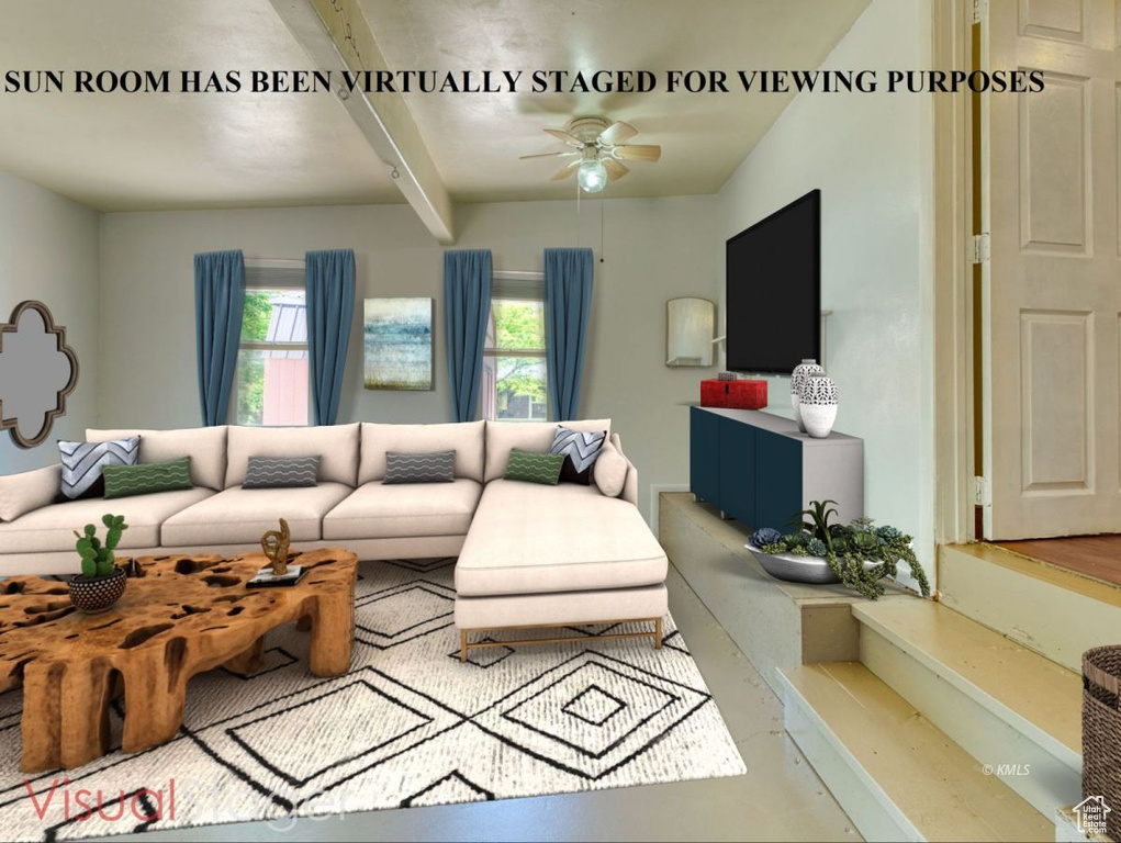 Living area featuring a ceiling fan and beam ceiling