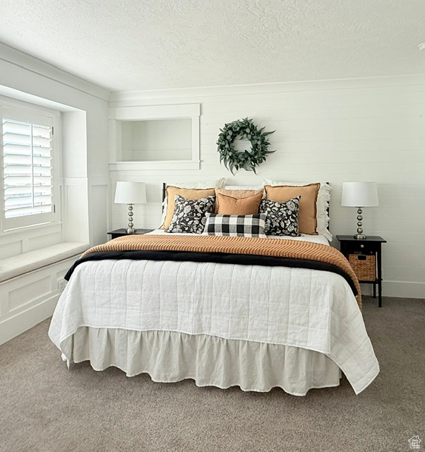 Bedroom with carpet and a textured ceiling