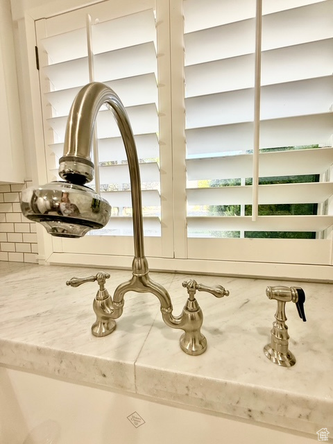 Interior details with decorative backsplash and a sink