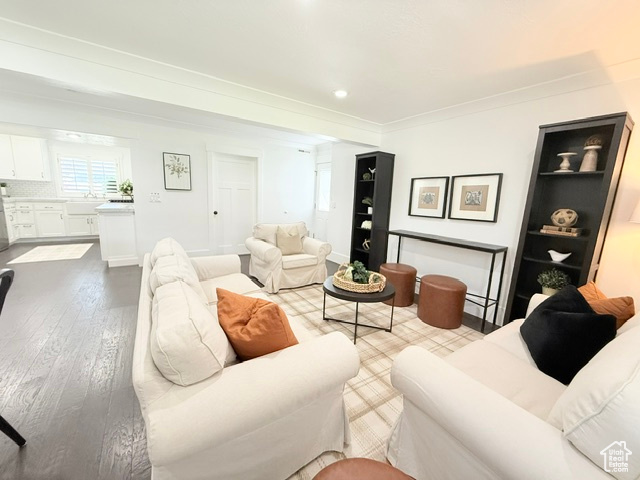 Living area featuring crown molding and wood finished floors