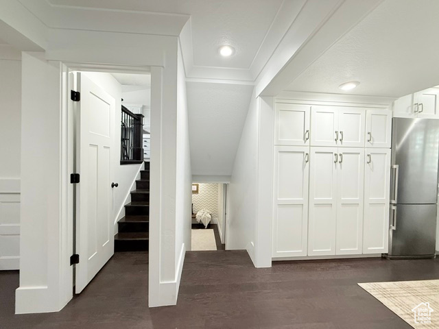 Stairway with recessed lighting, wood finished floors, and baseboards
