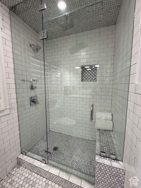 Full bathroom with tile patterned floors and a shower stall
