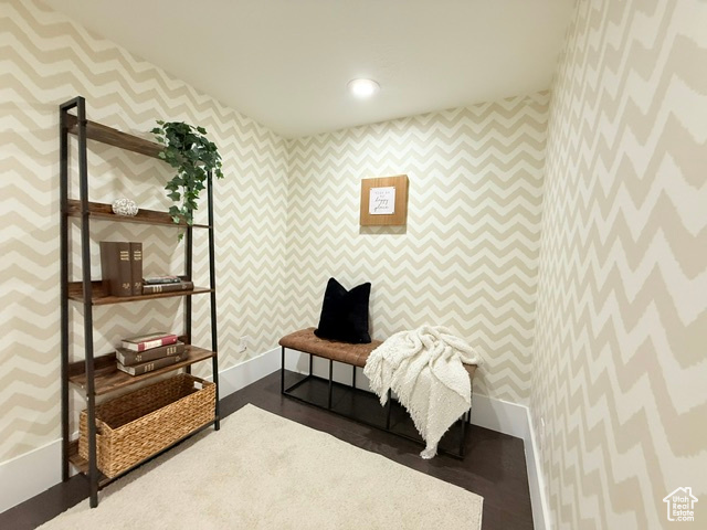 Living area featuring wallpapered walls, baseboards, and recessed lighting