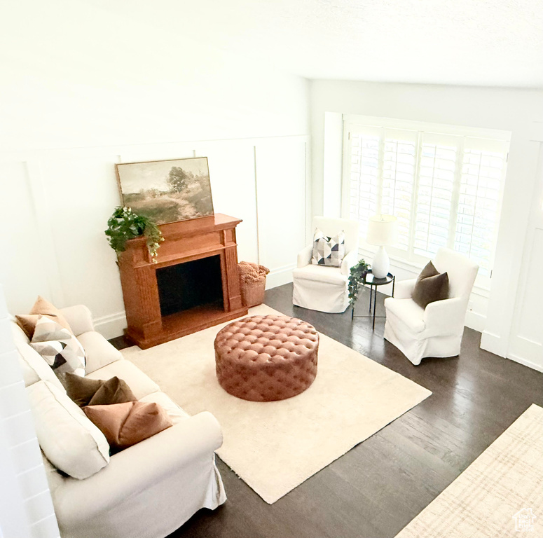 Living area with wood finished floors, baseboards, and a fireplace