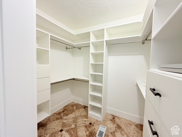 Spacious closet featuring visible vents