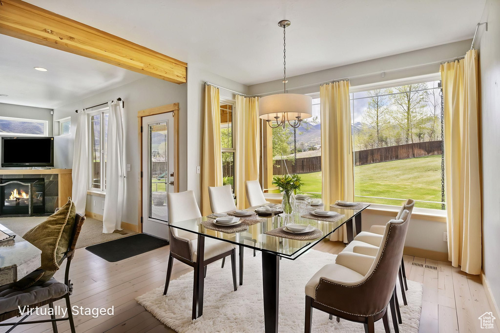 Dining room featuring recessed lighting, light wood finished floors, and a wealth of natural light