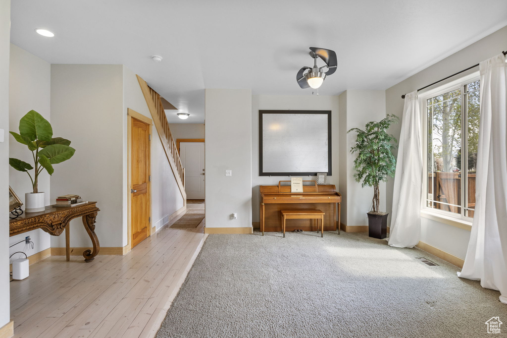 Sitting room with visible vents, stairs, baseboards, recessed lighting, and light wood finished floors