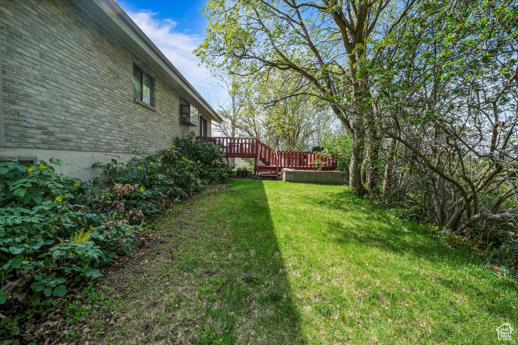 View of yard featuring a wooden deck